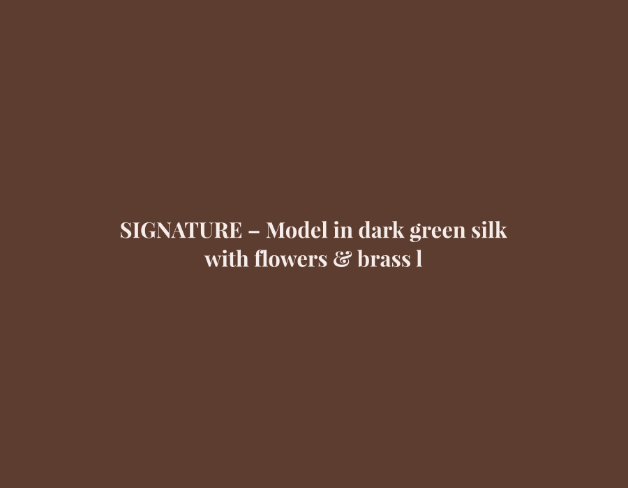 Woman in dark green silk saree with brass lamps